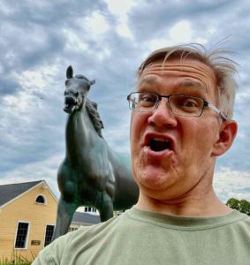 A selfie with a horse statue.